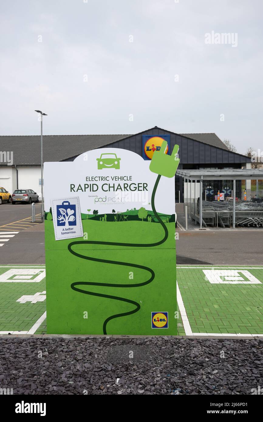 Lidl Supermarket Car Park, Montrose, Angus, Scotland,Uk. Installation of Electric Vehicle Charging Pointin car park, still in process of being installed with cover over the charger say 'Electric Vehicle Charging Coming Soon ' Stock Photo