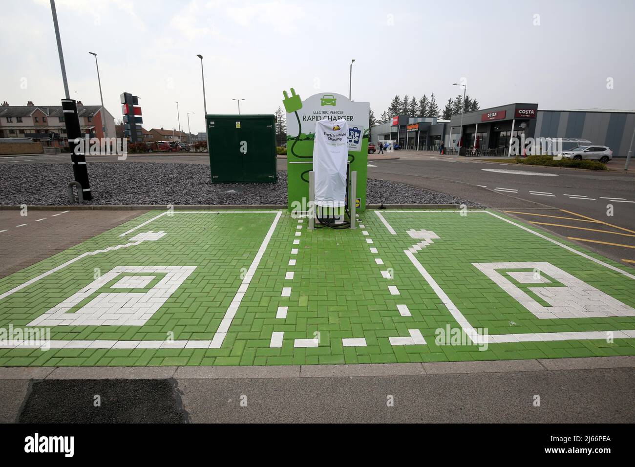 Lidl Supermarket Car Park, Montrose, Angus, Scotland,Uk. Installation of Electric Vehicle Charging Pointin car park, still in process of being installed with cover over the charger say 'Electric Vehicle Charging Coming Soon ' Stock Photo
