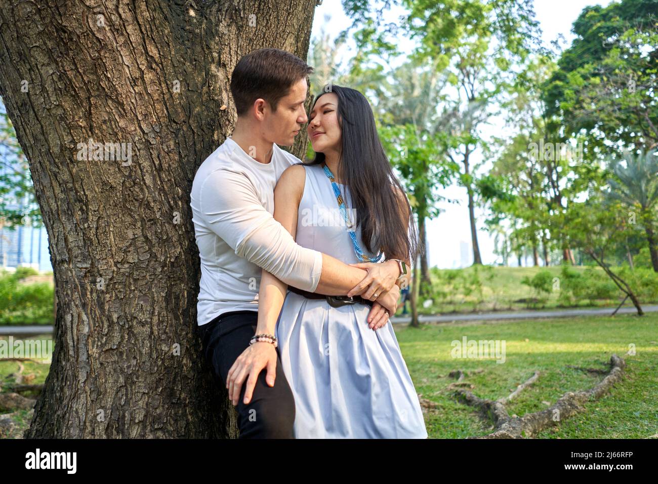 Female leaning against tree hi-res stock photography and images - Alamy