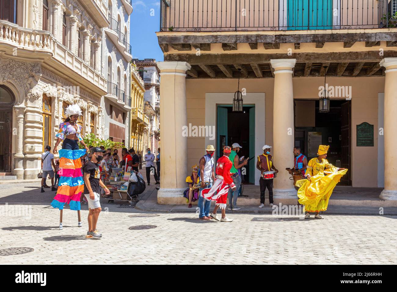 Conga dancers in stilts performing in Old Havana. They are wearing colorful traditional clothing. Stock Photo