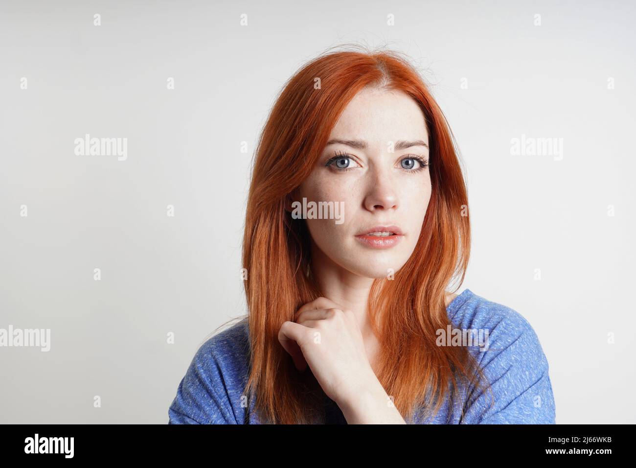 contemplative mid adult woman thinking with neutral but positive expression Stock Photo