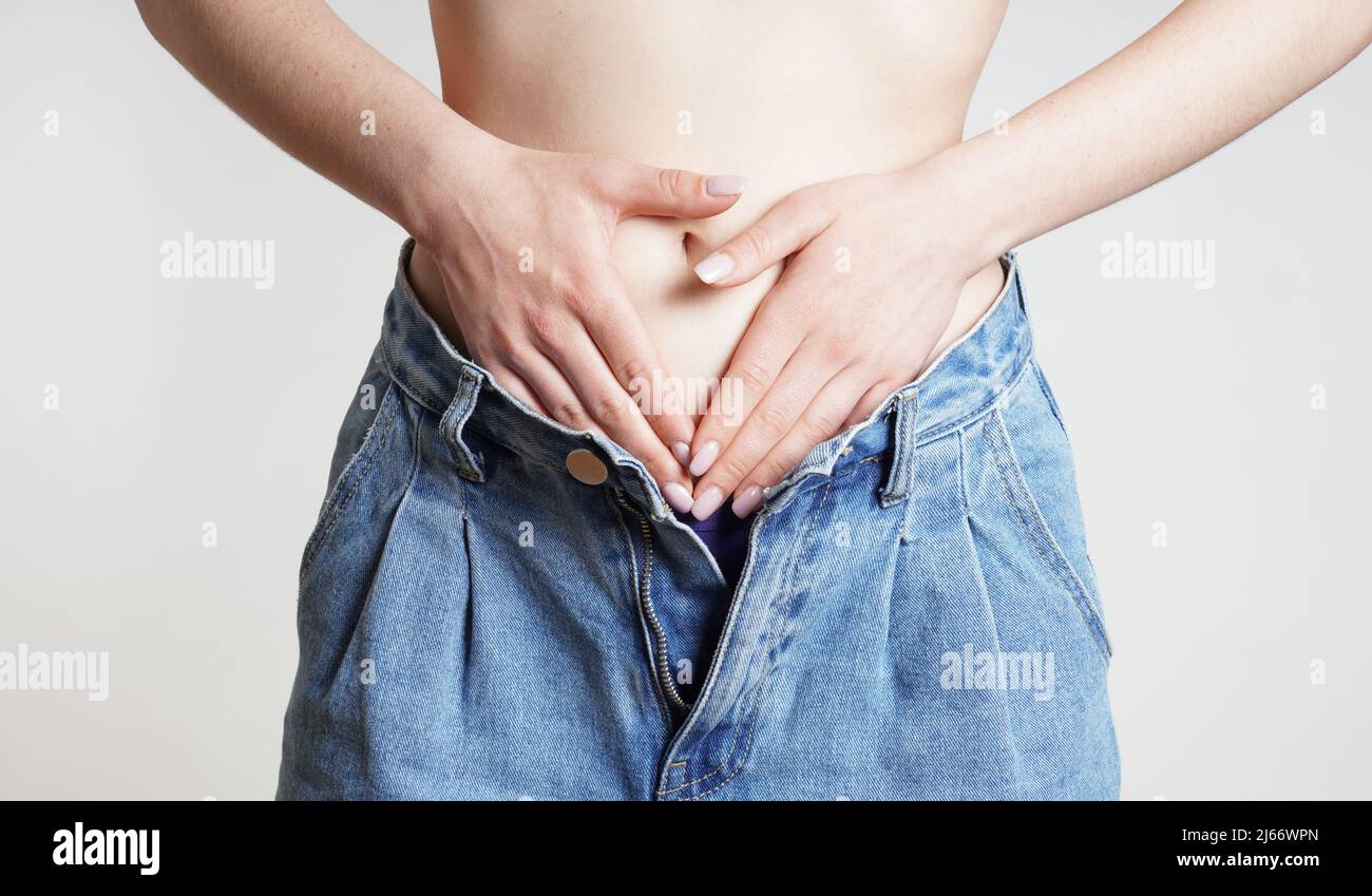 woman holding belly with abdominal or period pains Stock Photo