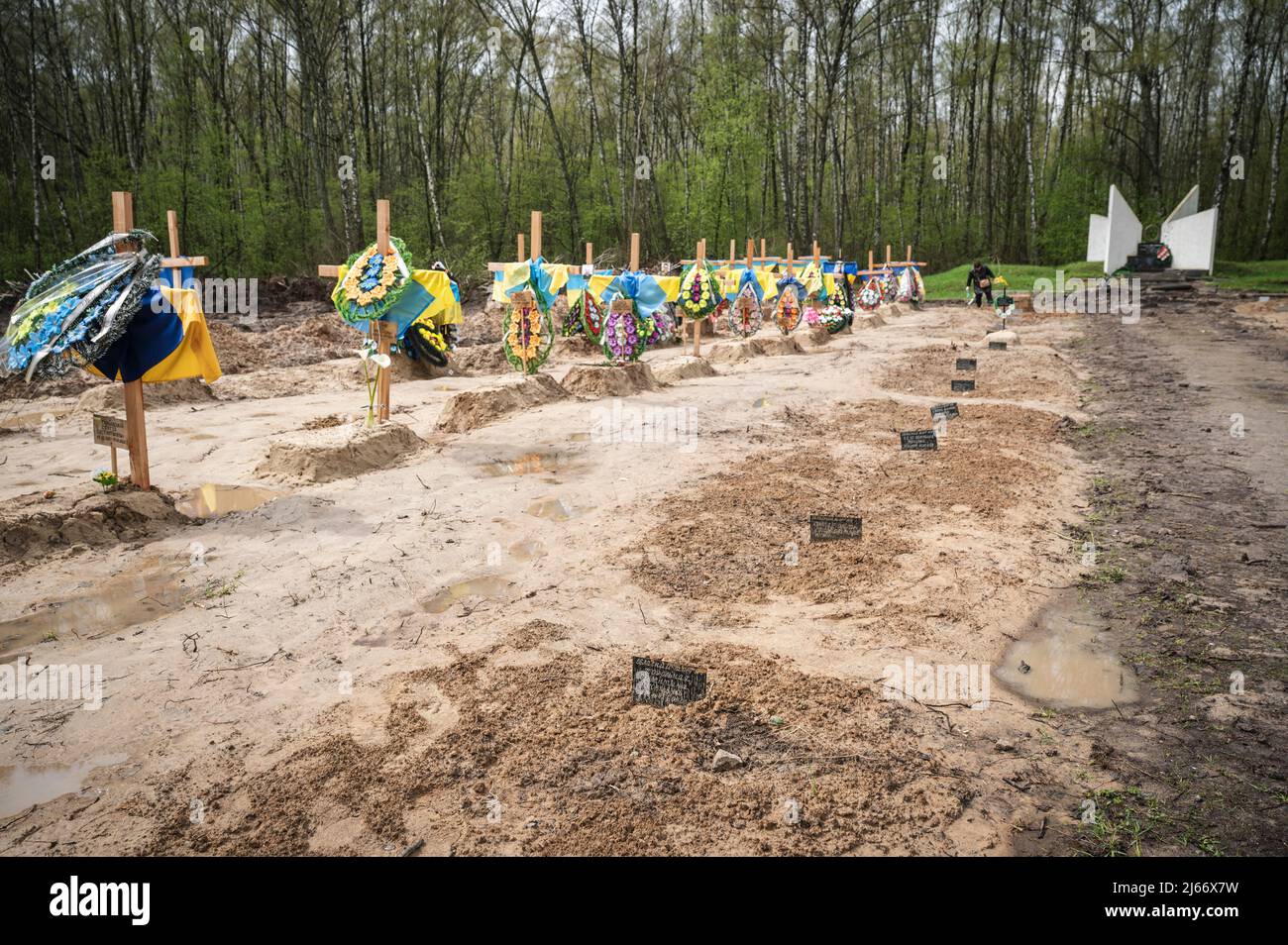 Signs with deceased people's names in the ground seen at the mass grave area. A mass grave for