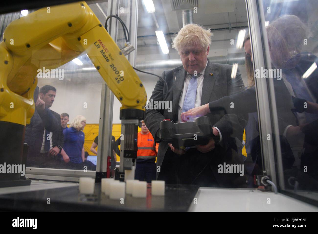 Britain's Prime Minister Boris Johnson operates a robotic arm during a campaign visit to Burnley College Sixth Form Centre in Burnley, Lancashire, Britain April 28, 2022. Peter Byrne/Pool via REUTERS Stock Photo