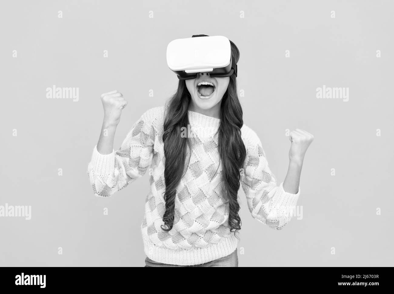 child in virtual reality goggles. modern wireless technology. childhood development. happy teen girl Stock Photo
