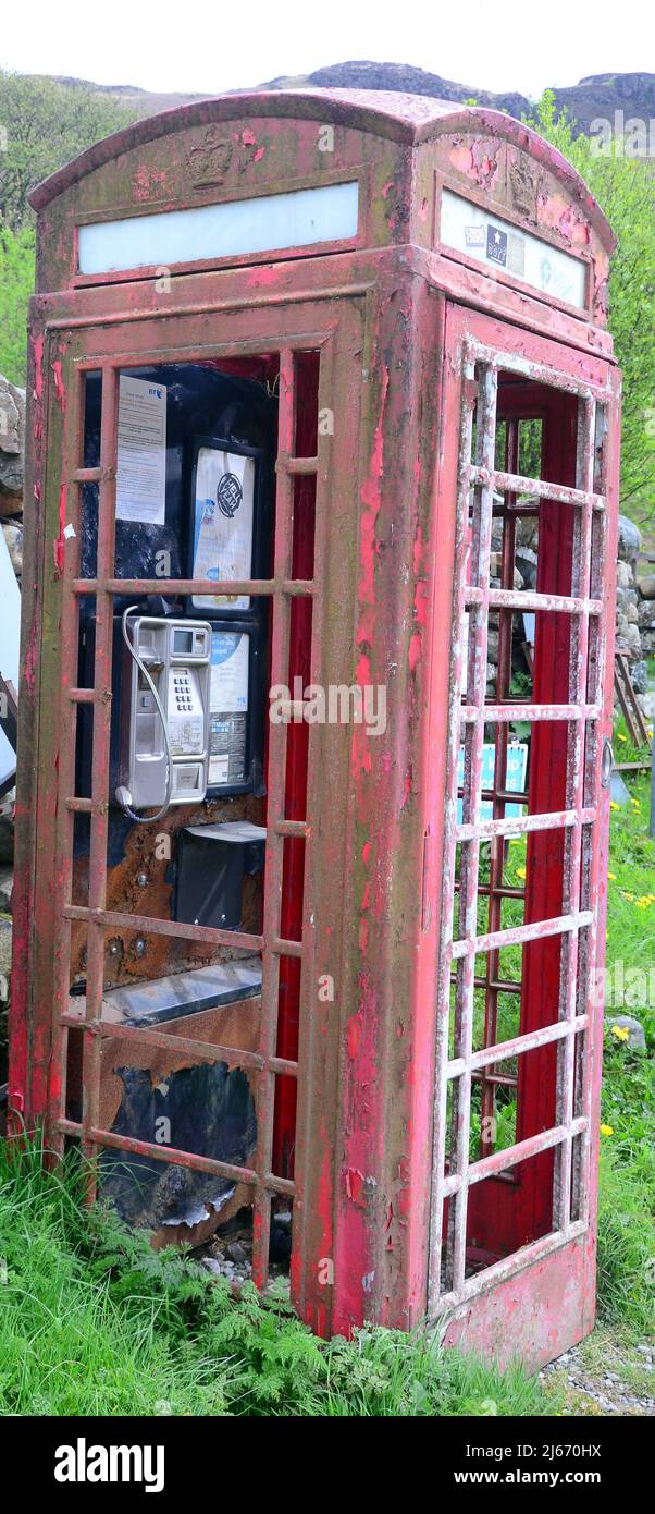 Vandalised phone box in Eskdale, Cumbria, England, United Kingdom, British Isles. Ofcom’s universal service obligation stipulates that BT must ‘provide a reasonable number of working phone boxes where they’re most needed.’ Ofcom recently carried out a review of this, noting that 'whilst over 99% of UK premises have coverage for mobile telephone calls from all operators, the total UK geographic area covered by all operators is only 80% (and drops to 59% in Scotland).' Stock Photo