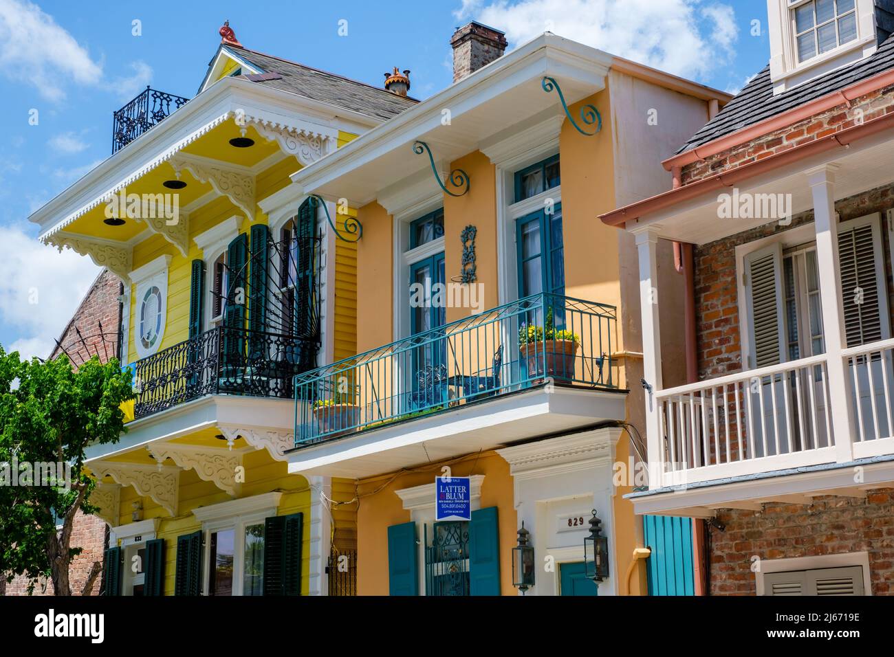 NEW ORLEANS, LA, USA - APRIL 21, 2022: Front of three colorful historic homes in the French Quarter Stock Photo