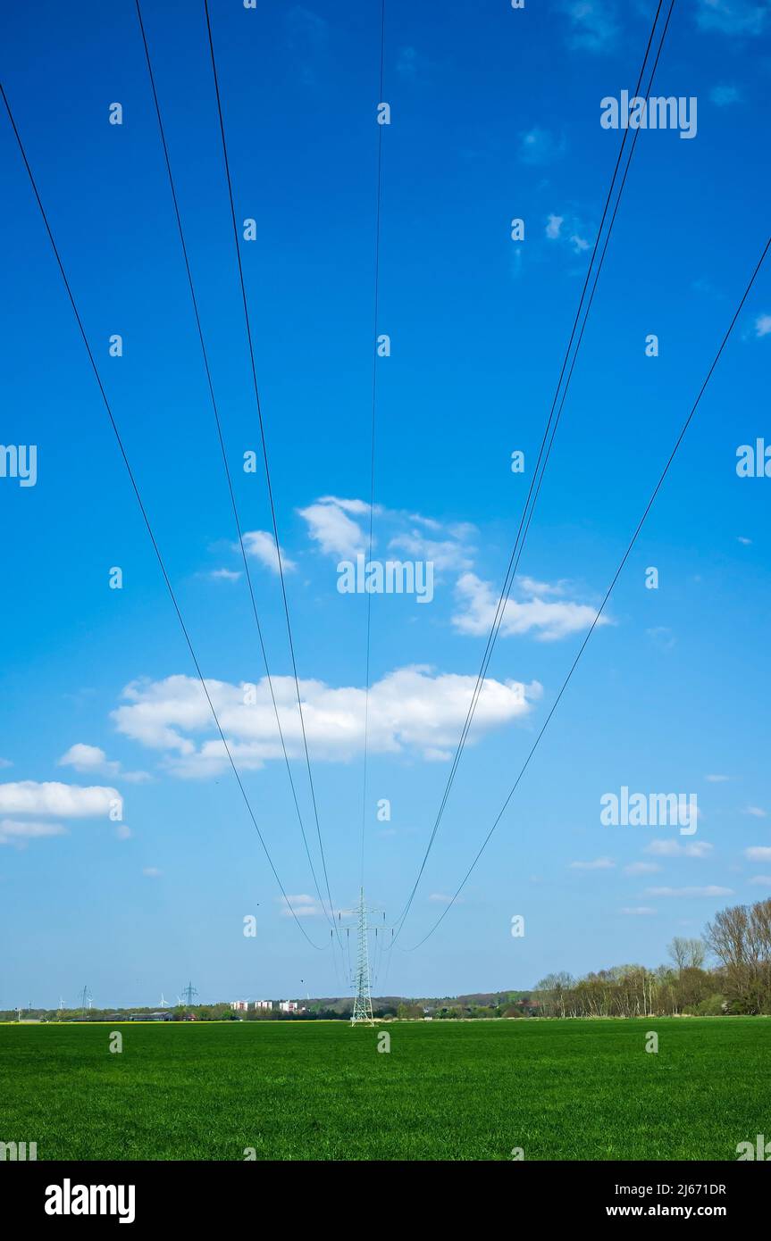 High metal electricity pylons with power lines that pass over an ...