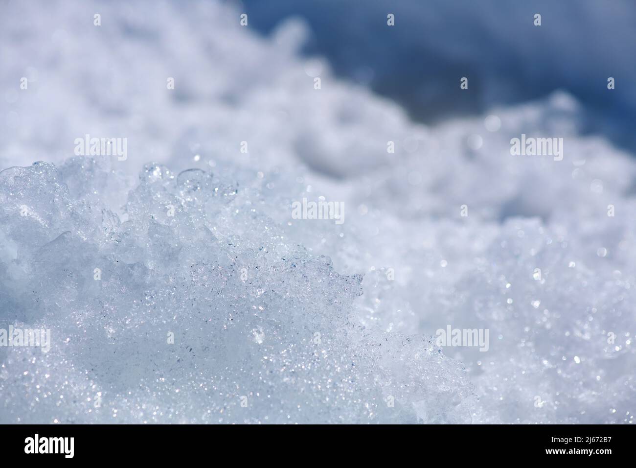 Snow crystalline background close-up. White with blue. Stock Photo