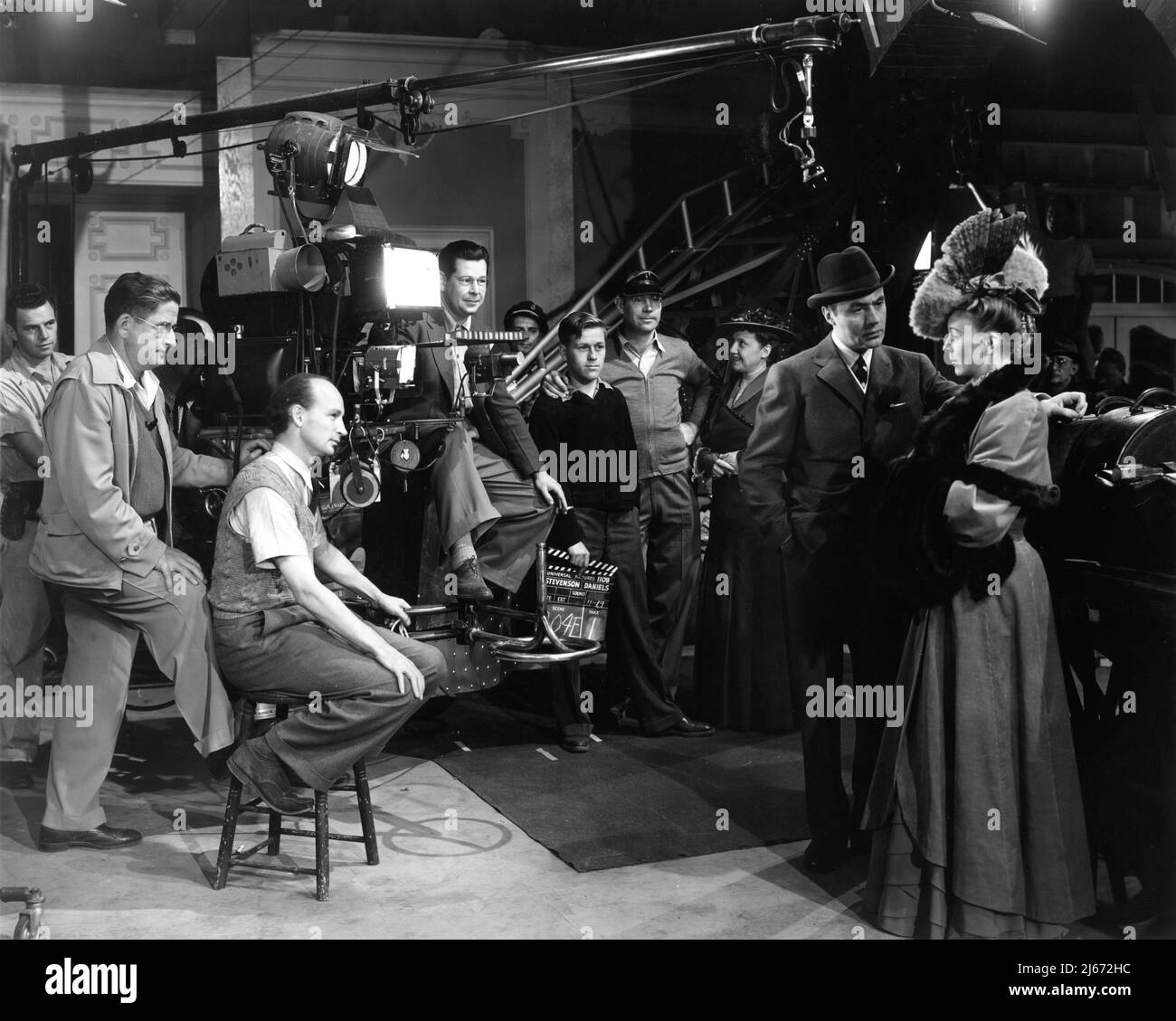 Director ROBERT STEVENSON and Movie Crew on set candid filming CHARLES BOYER and MARGARET SULLAVAN in BACK STREET 1941 director ROBERT STEVENSON novel Fannie Hurst screenplay Bruce Manning and Felix Jackson cinematography William H. Daniels music Frank Skinner costume design Vera West Universal Pictures Stock Photo