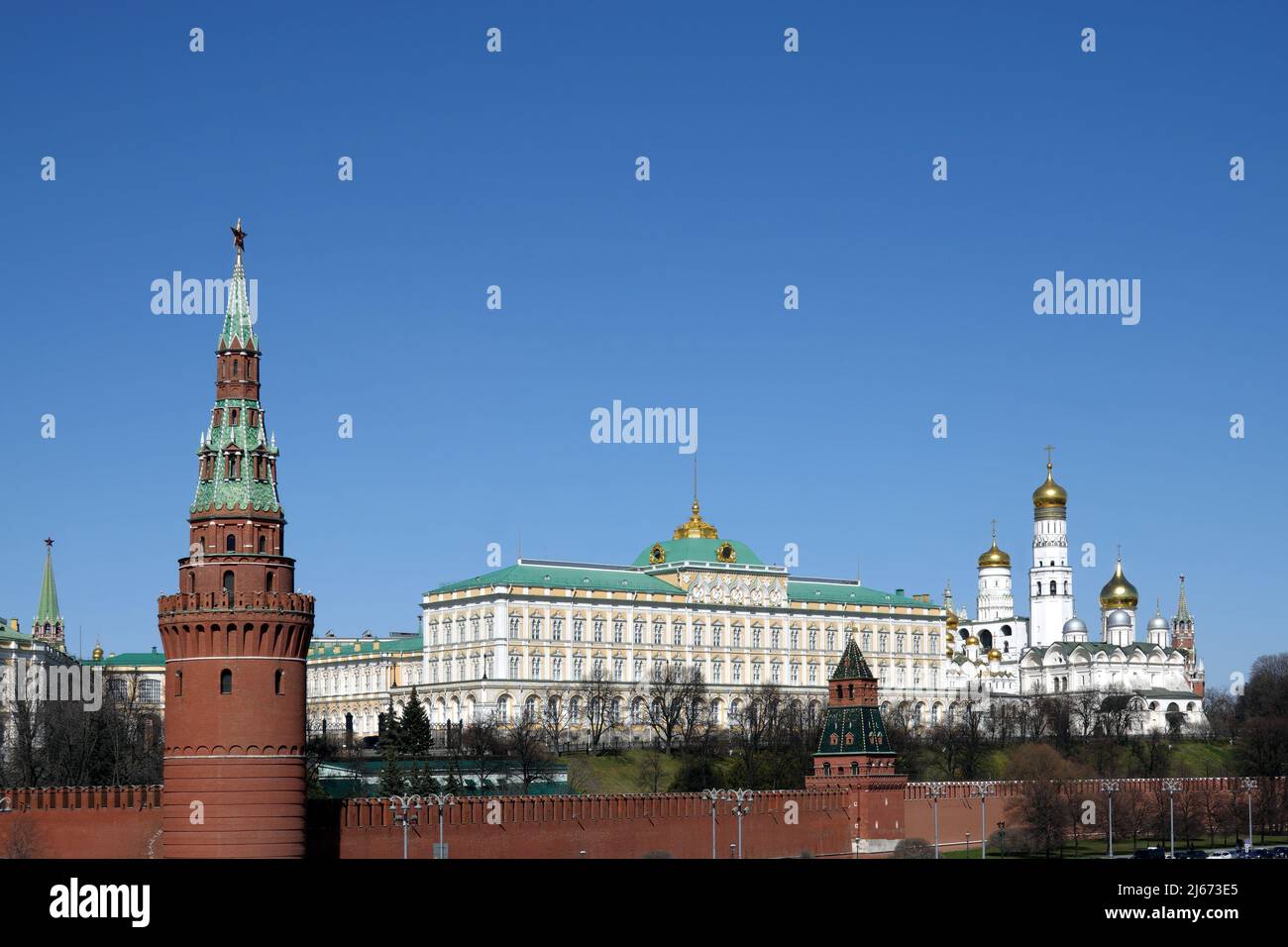 Vodovzvodnaya tower, Grand Kremlin Palace and Ivan the Great Bell Tower of Moscow Kremlin behind the wall on embankment ot the Moscow river on bright Stock Photo