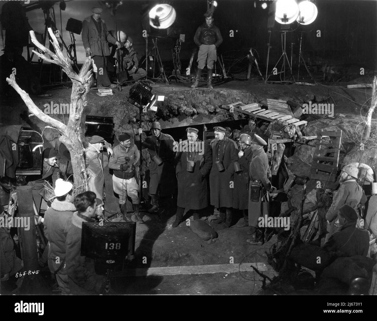 Director JAMES WHALE (by camera with cigarette in mouth) Cinematographer JOHN J. MESCALL (to right of tree) ANDY DEVINE SLIM SUMMERVILLE and JOHN EMERY on set candid during filming of THE ROAD BACK 1937 director JAMES WHALE novel Erich Maria Remarque screenplay Charles Kenyon and R.C. Sherriff music Dimitri Tiomkin art direction Charles D. Hall Universal Pictures Stock Photo