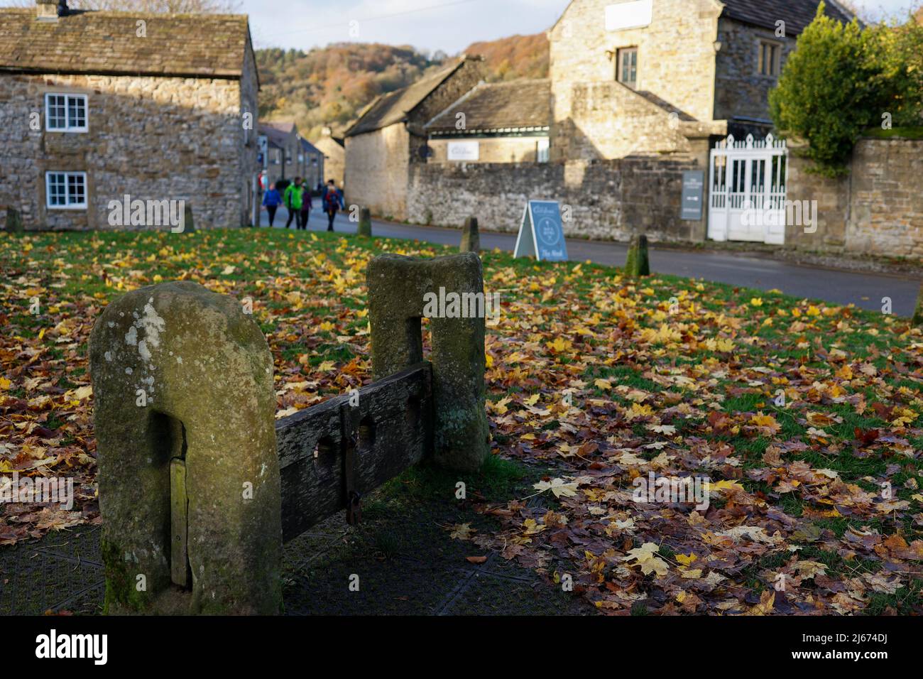 Old punishment stocks in the Derbyshire village of Eyam Stock Photo