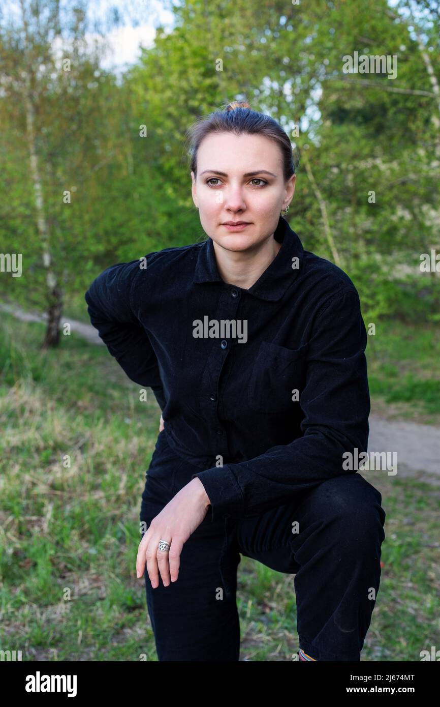 portrait of young brunette woman in park relaxing Stock Photo - Alamy