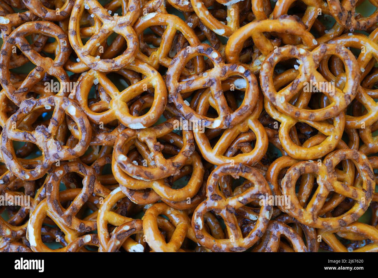 Mini pretzels snacks with salt as a background Stock Photo