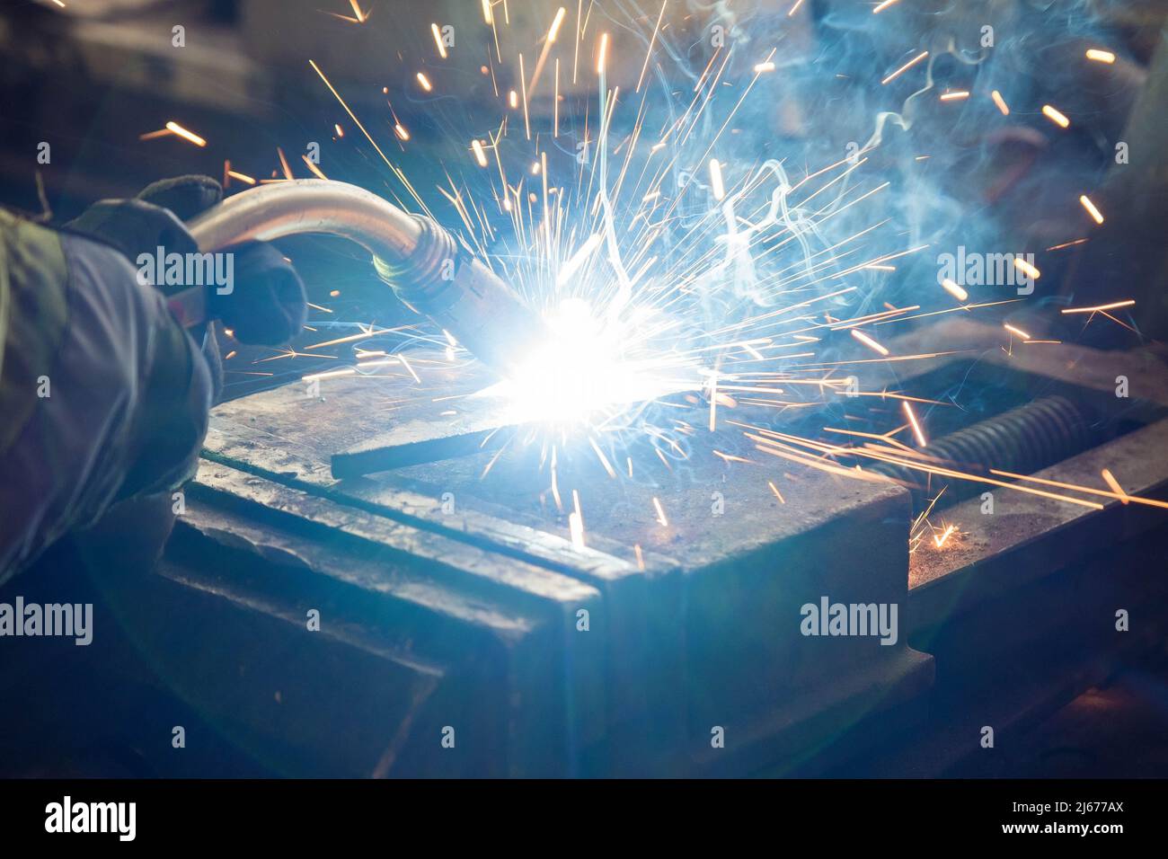 Welding of steel, sparking, not wearing gloves, light colored like fireworks Stock Photo