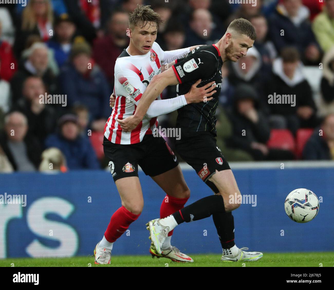SUNDERLAND, UK. APR 26TH  Callum Doyle of Sunderland battles with Michael Smith of Rotherham United  during the Sky Bet League 1 match between Sunderland and Rotherham United at the Stadium Of Light, Sunderland on Tuesday 26th April 2022. (Credit: Mark Fletcher | MI News) Stock Photo