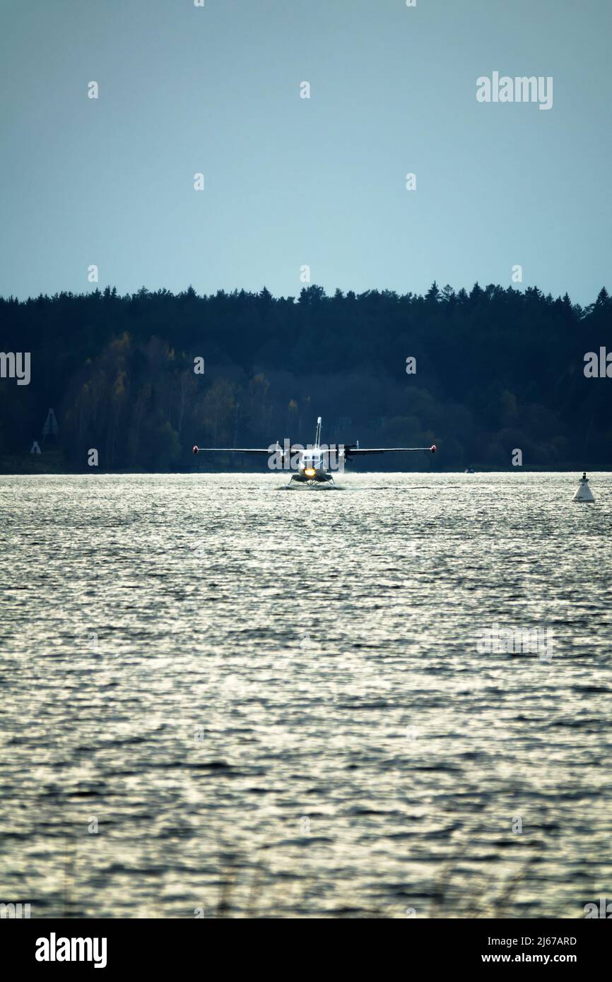 The Twinengine seaplane a seaplane rises from water, from the forest