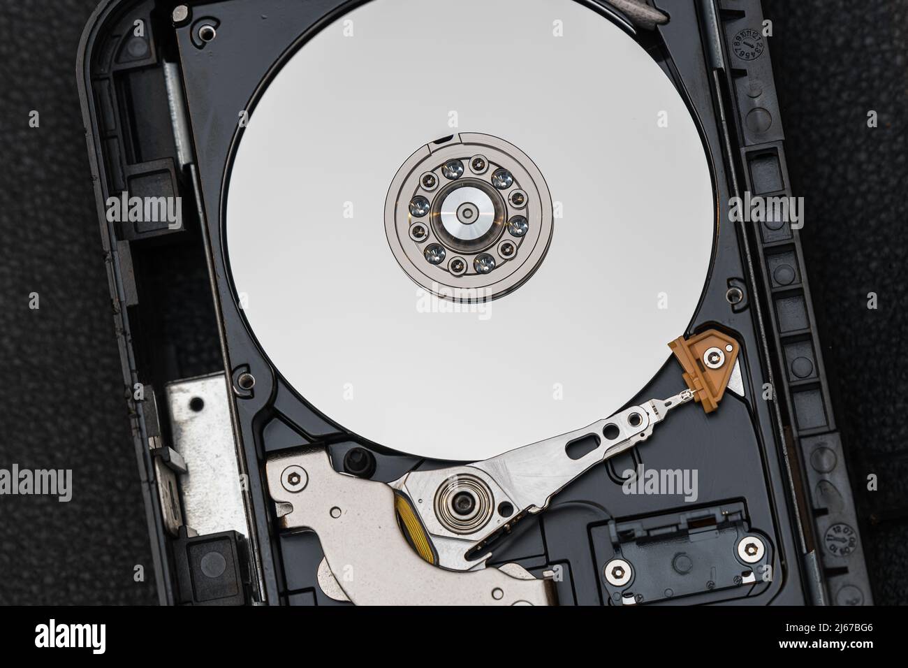 Mechanical parts of hard drive disk (HDD) inside a computer Stock Photo