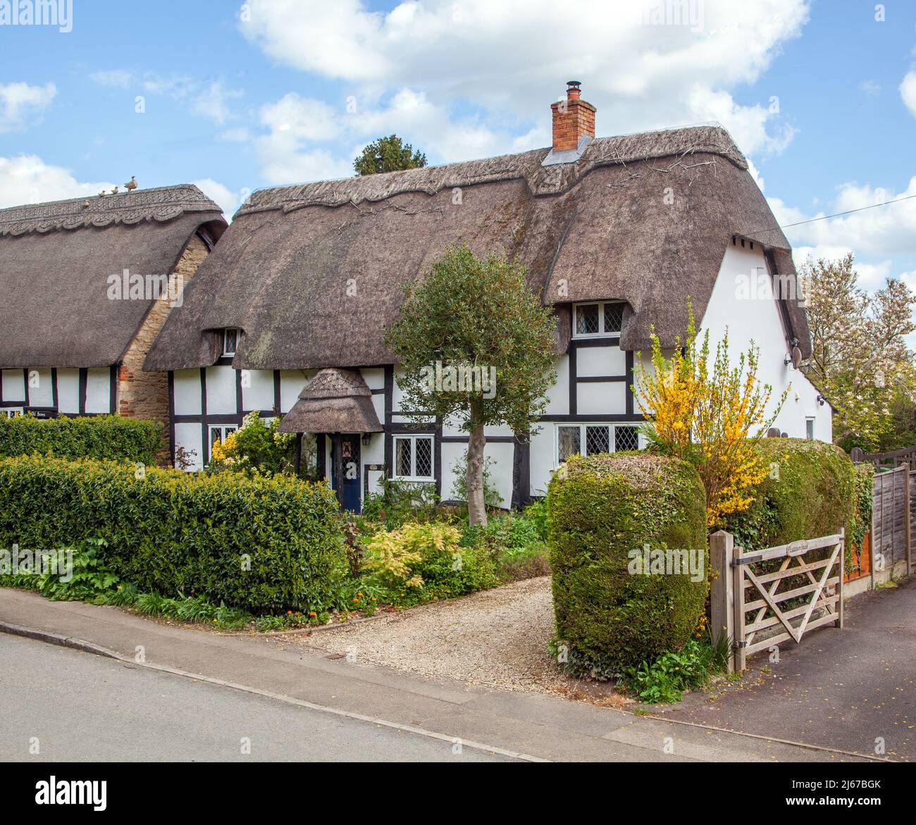 Half timbered black and white thatched country cottages at Ashton under Hill a village in  Worcestershire England.at the foot of the Bredon Hills Stock Photo