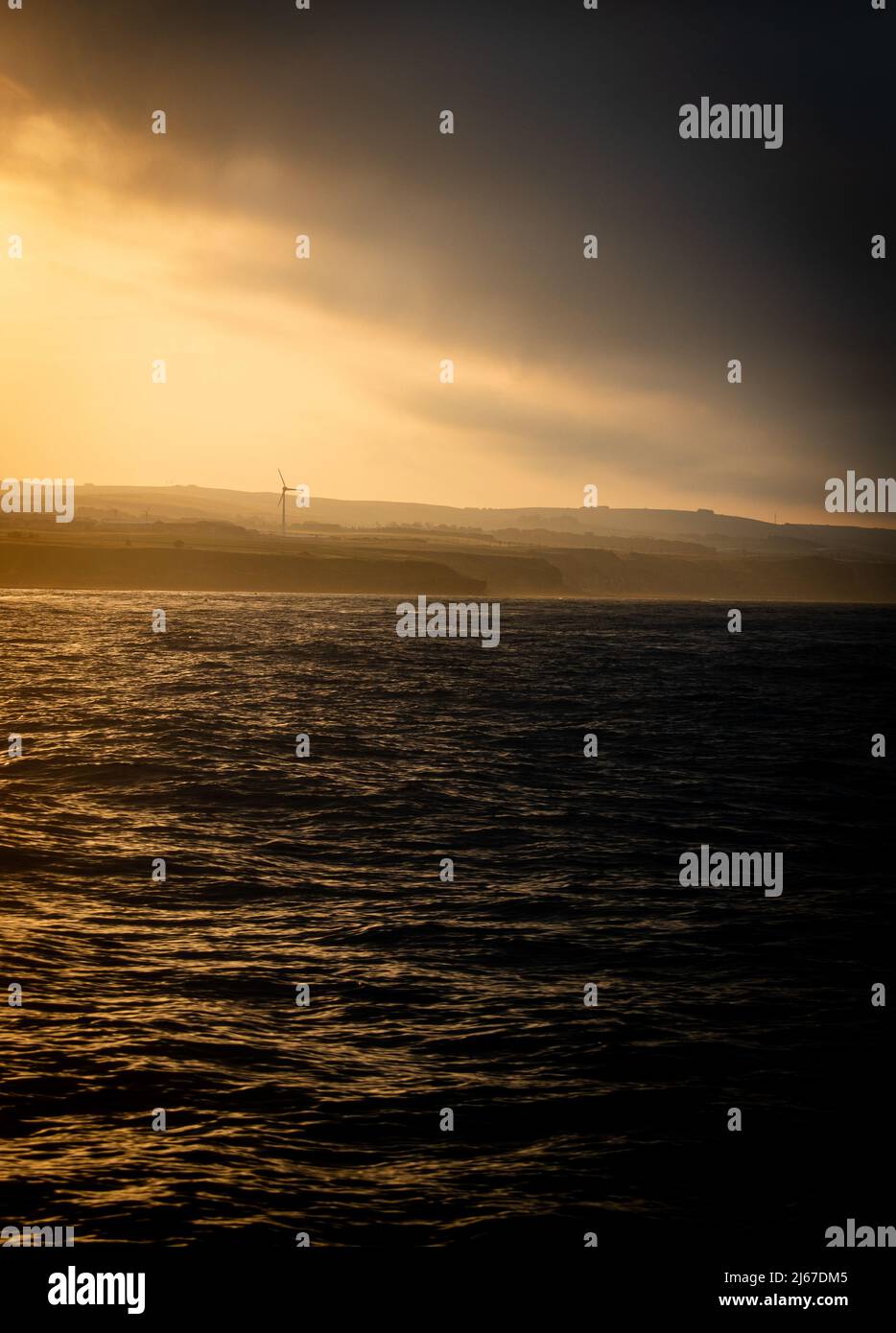 A photo take whilst caught between a storm and a sunset off the coast of Berwick-Upon-Tweed Stock Photo