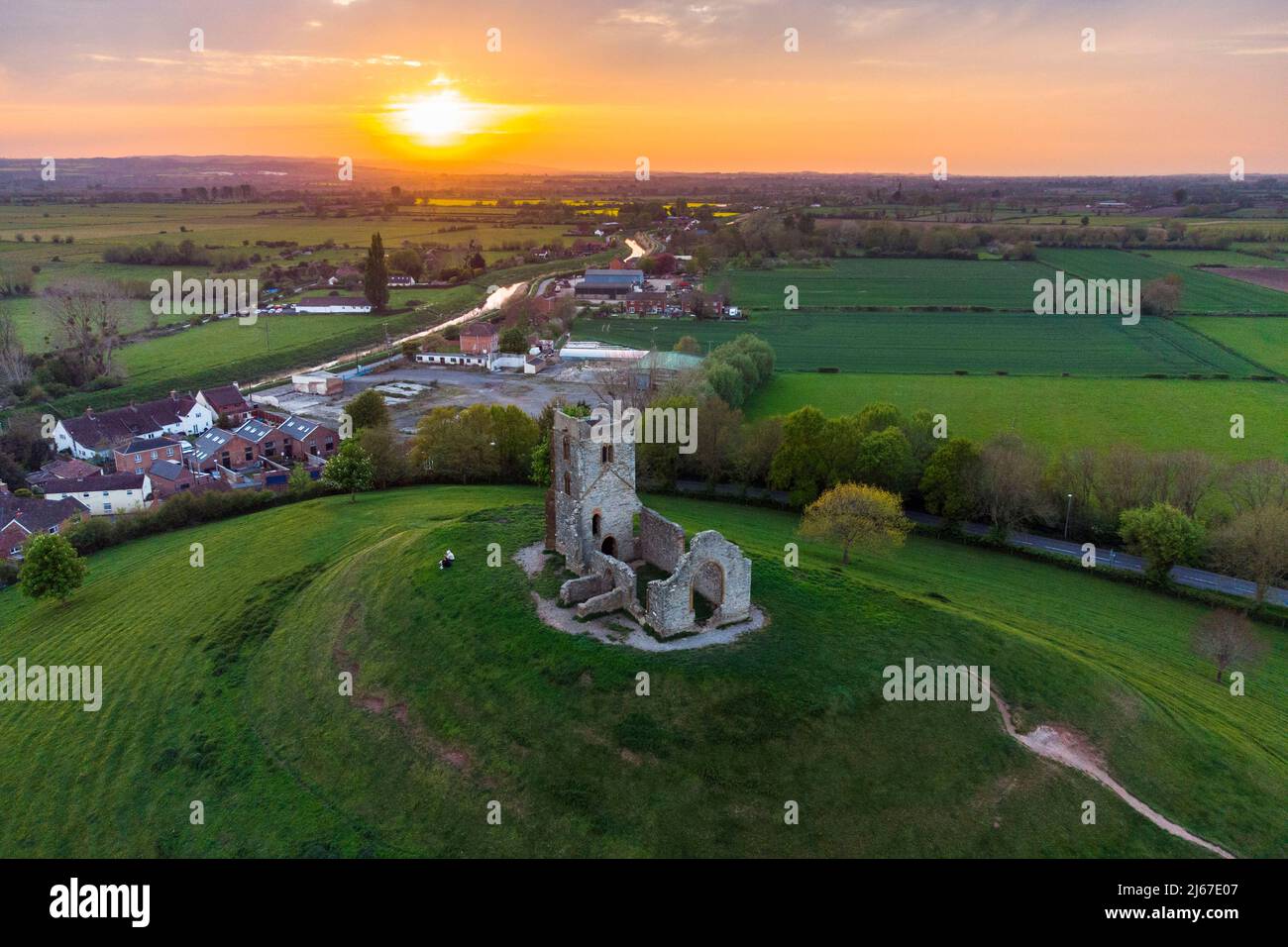 Burrowbridge, Somerset, UK.  28th April 2022.  UK Weather.  View from the air at sunset of the ruined church on top of Burrow Mump at Burrowbridge in Somerset.  Picture Credit: Graham Hunt/Alamy Live News Stock Photo