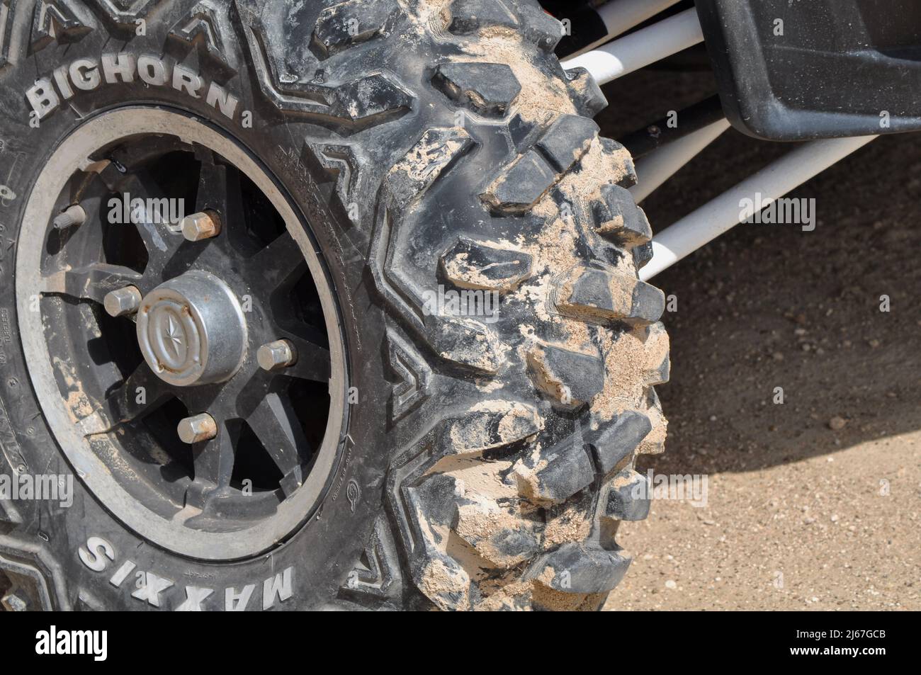 Wheel of all terrain vehicle buggy for racing across desert dunes after safari journey. Abu Dhabi,UAE Stock Photo
