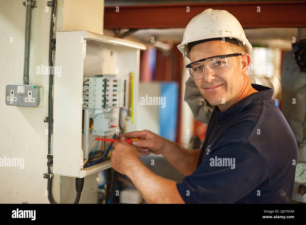 Maintenance engineer working and looking ta the camera Stock Photo