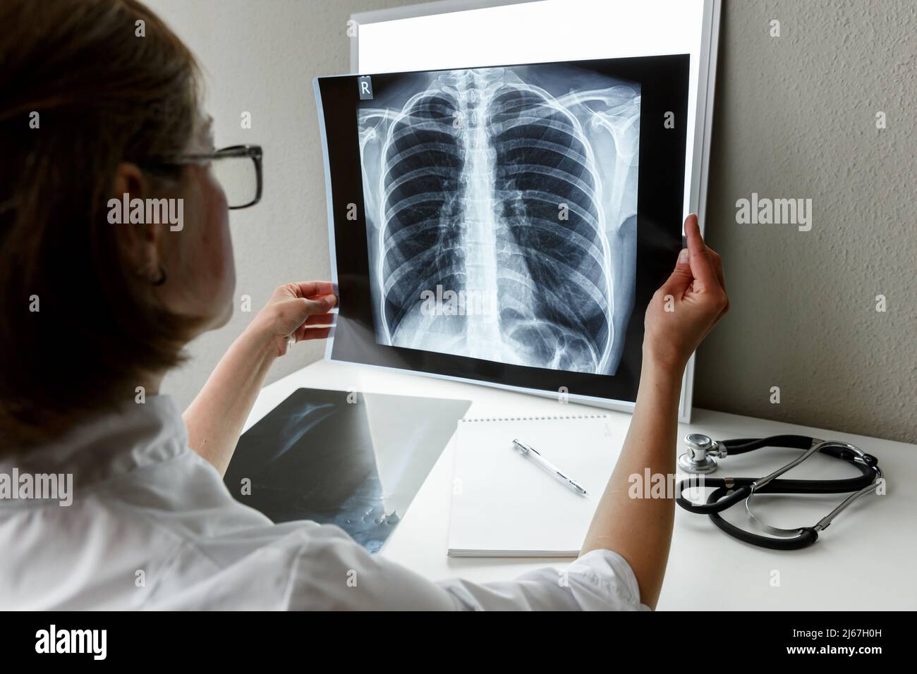 Pulmonologist therapist examining an x-ray of lungs. Health care and medical insurance concept Stock Photo