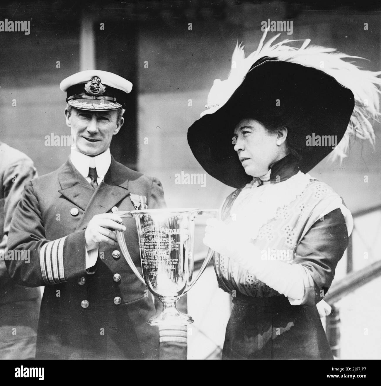 Mrs. J.J. 'Molly' Brown presenting trophy cup award to Capt. Arthur Henry Rostron, for his service in the rescue of the Titanic - 1912 Stock Photo