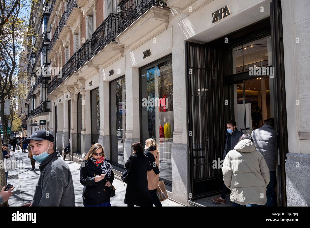 Pedestrians walk past the Spanish multinational clothing design retail ...