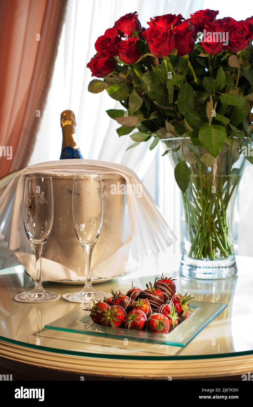 Red roses and champaign in a luxury hotel suite Stock Photo