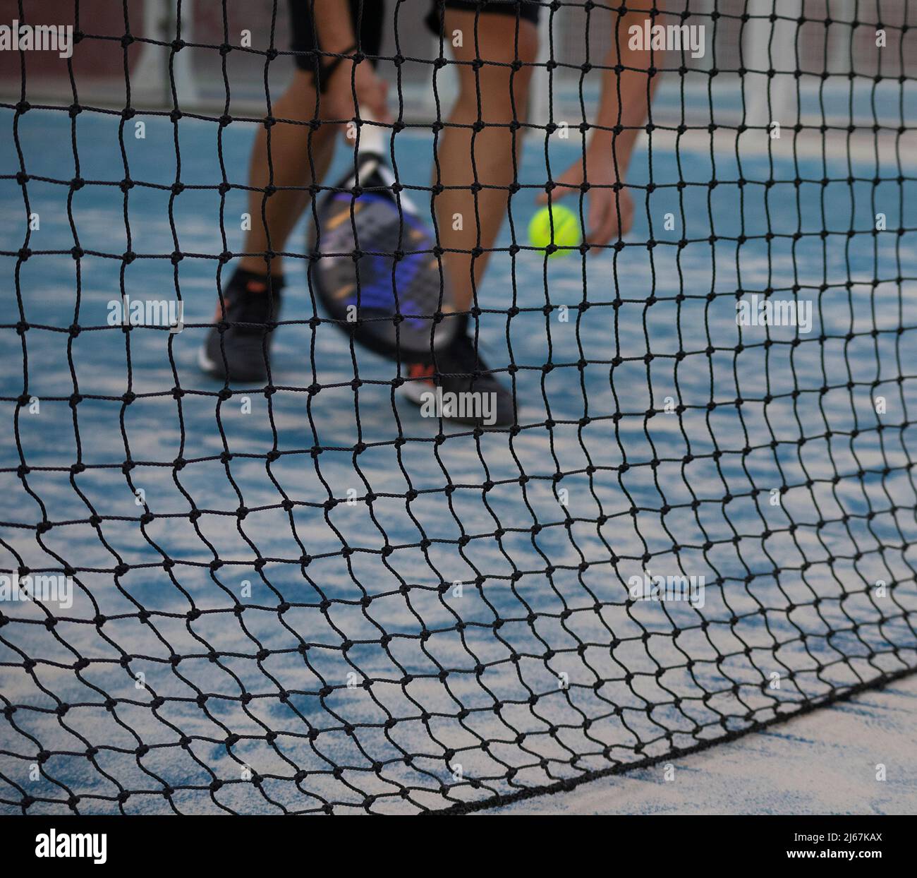 sportsman playing paddle tennis on an outdoor court Stock Photo