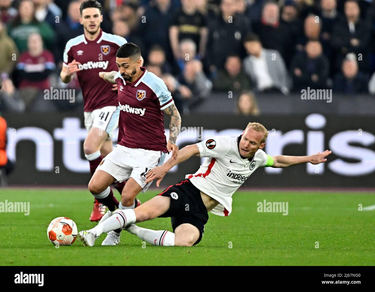 London UK 28th April 2022. Manuel Lanzini (West Ham) is tackled by Sebastian Rode (Frankfurt) during the West Ham vs Eintracht Frankfurt Uefa Europa Cup semi final 1st leg match at the London Stadium, Stratford.Credit: Martin Dalton/Alamy Live News. This Image is for EDITORIAL USE ONLY. Licence required from the the Football DataCo for any other use. Credit: MARTIN DALTON/Alamy Live News Stock Photo