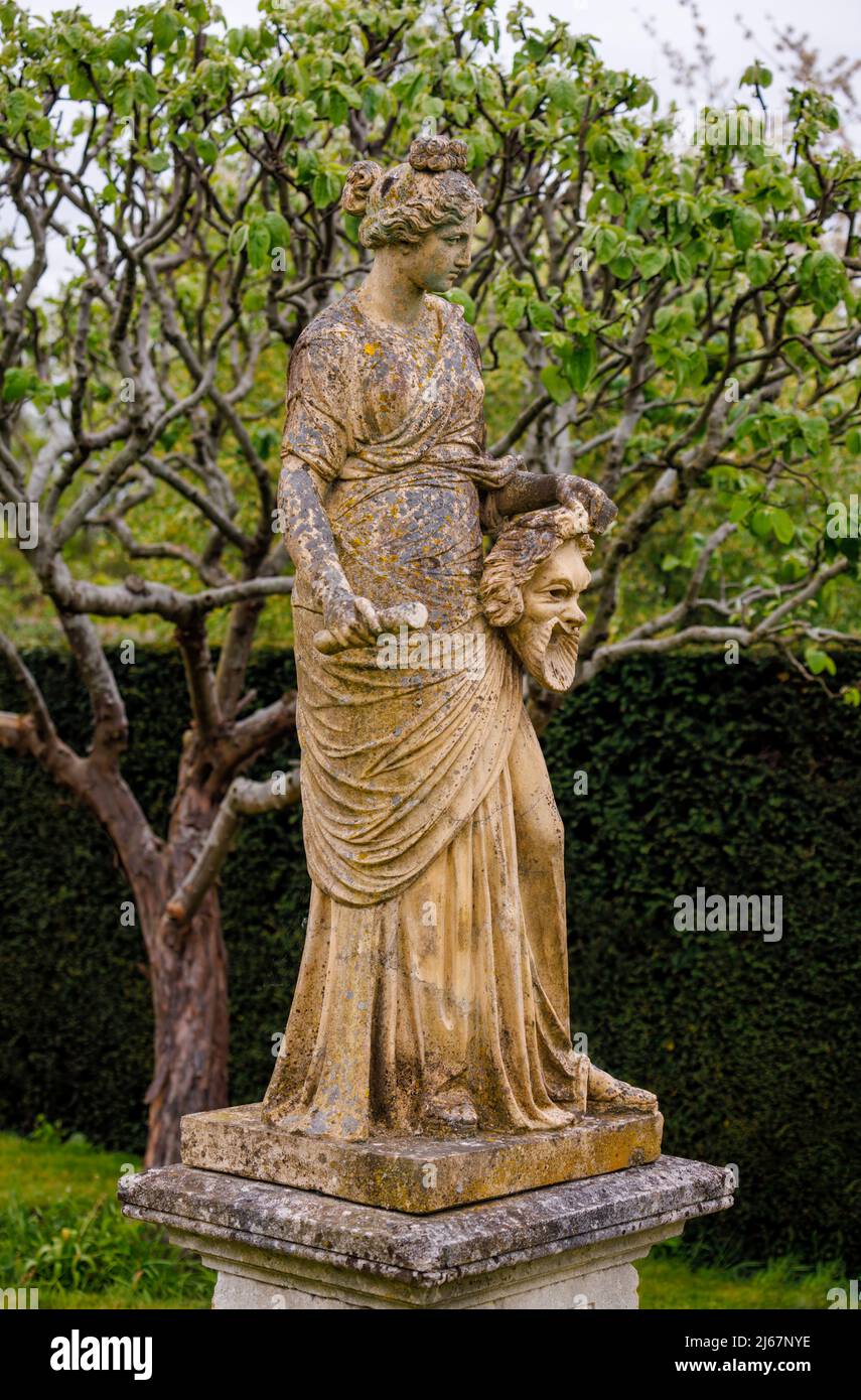 Statue of a Greek Muse, probably Melpomene, in the gardens of Dunsborough Park, Ripley, Surrey, south-east England in April Stock Photo