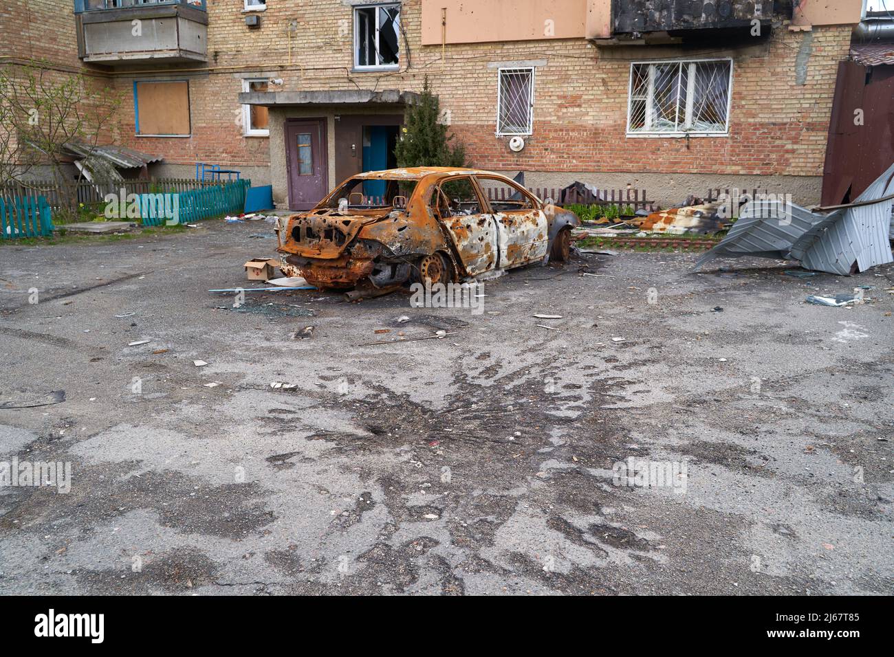 2022 Russian invasion of Ukraine war torn city destroyed car burn out. Russia war damage building destruction city war ruins city damage car. Terror a Stock Photo