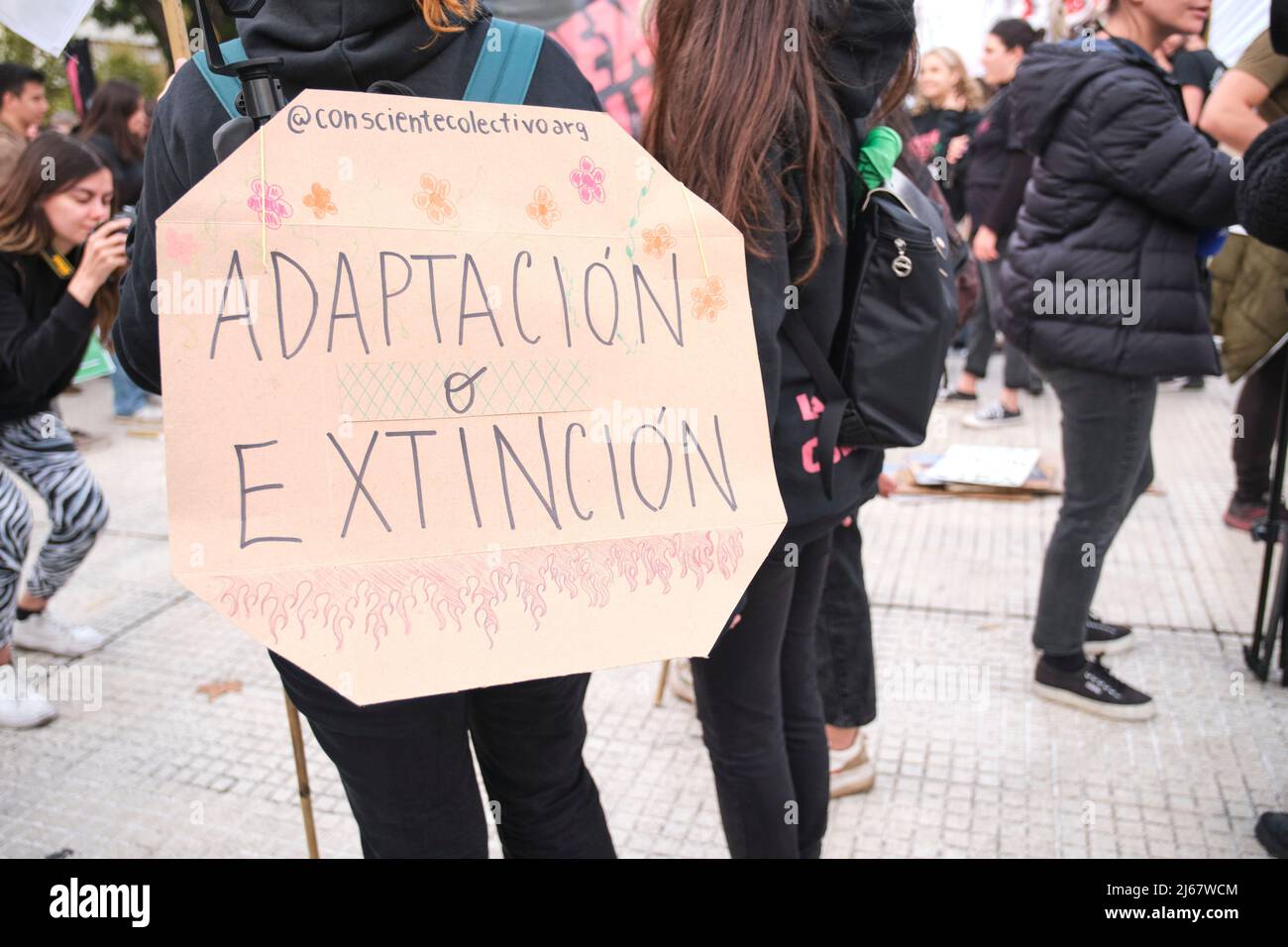 Buenos Aires, Argentina; April 22, 2022: Earth Day demonstration; poster with the message Adaptation or extinction. Concepts: activism, environmentali Stock Photo
