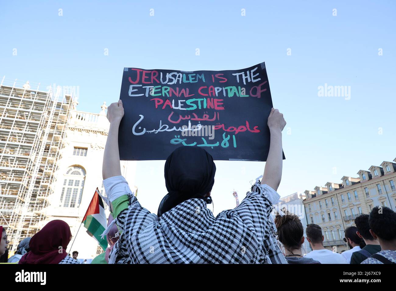 Turin, Italy. 28th April, 2022. A woman protests against the raids of Israeli forces in West Bank and restrictions on access to holy sites in Jerusalem during the Ramadan time holding a placard showing:“Jerusalem is the eternal capital of Palestine”. Credit: MLBARIONA/Alamy Live News Stock Photo