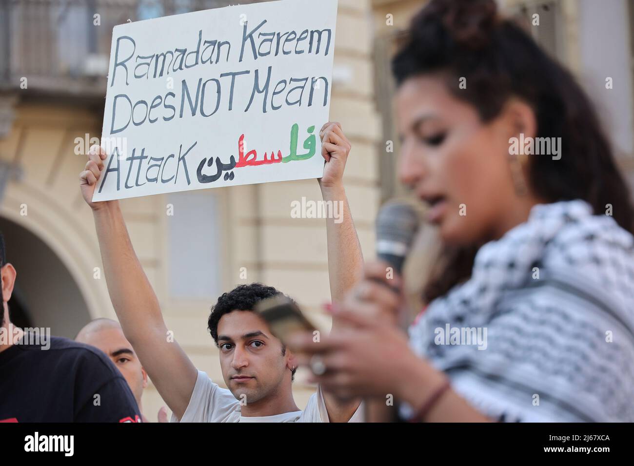 Turin, Italy. 28th April, 2022. A man protests against the raids of Israeli forces in West Bank and restrictions on access to holy sites in Jerusalem during the Ramadan time holding a placard showing:“Ramadan Kareem does not mean attack”. Credit: MLBARIONA/Alamy Live News Stock Photo