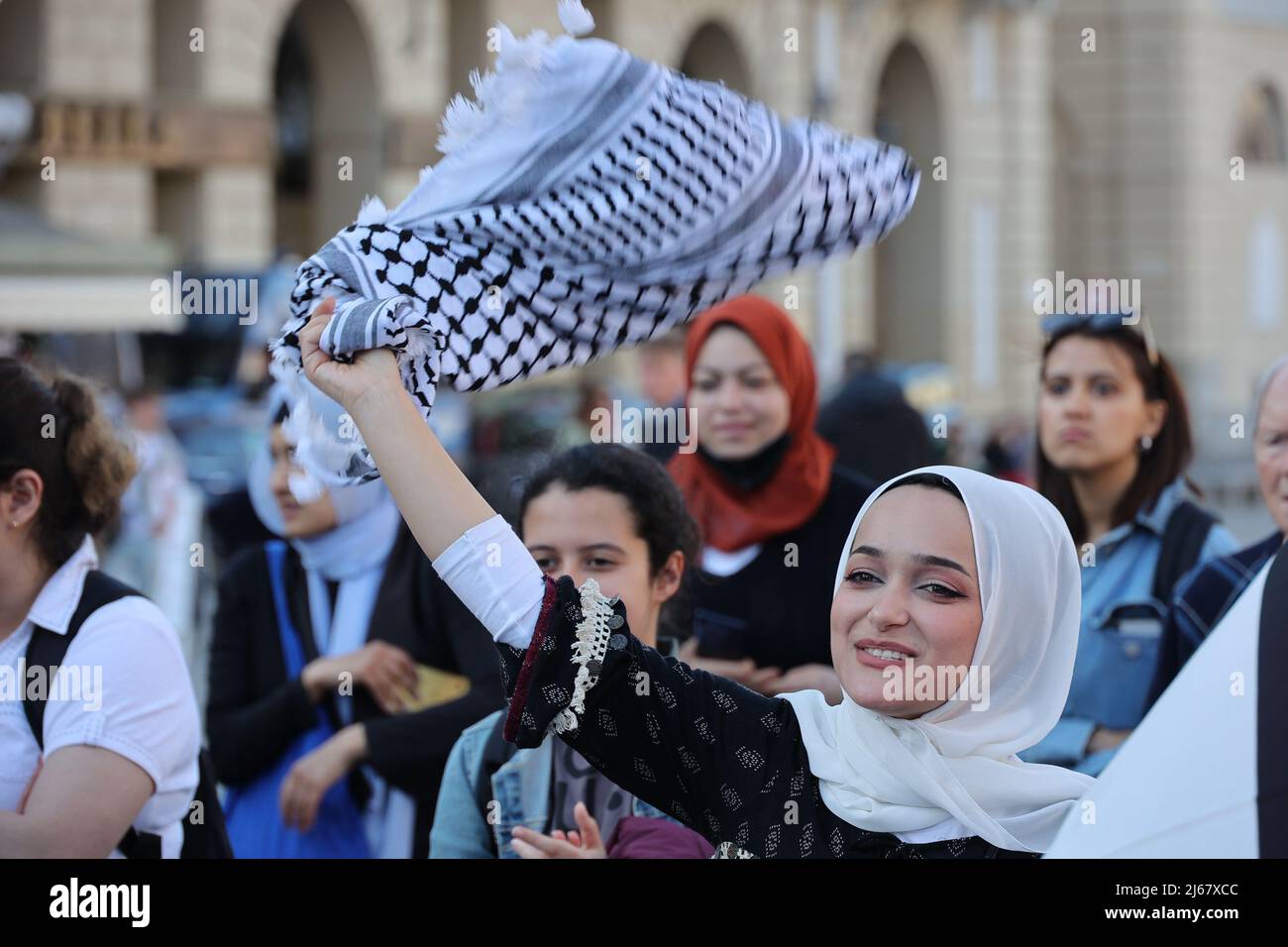 Turin, Italy. 28th April, 2022. A woman waves her keffiyeh at a protest against the raids of Israeli forces in West Bank and restrictions on access to holy sites in Jerusalem during the Ramadan time. Credit: MLBARIONA/Alamy Live News Stock Photo