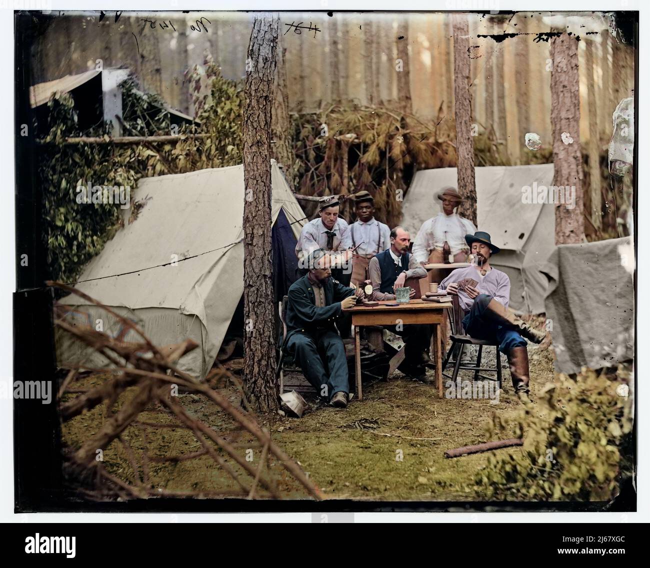 Officers of the 114th Pennsylvania Infantry drinking alcohol and playing cards in front of tents. August 1864 Stock Photo
