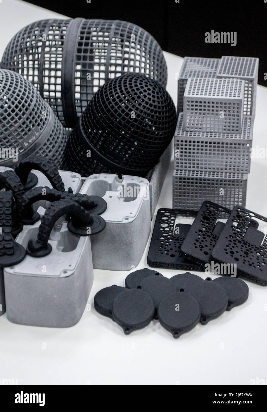 Many different models printed on 3D printer. Gray and black objects printed Stock Photo