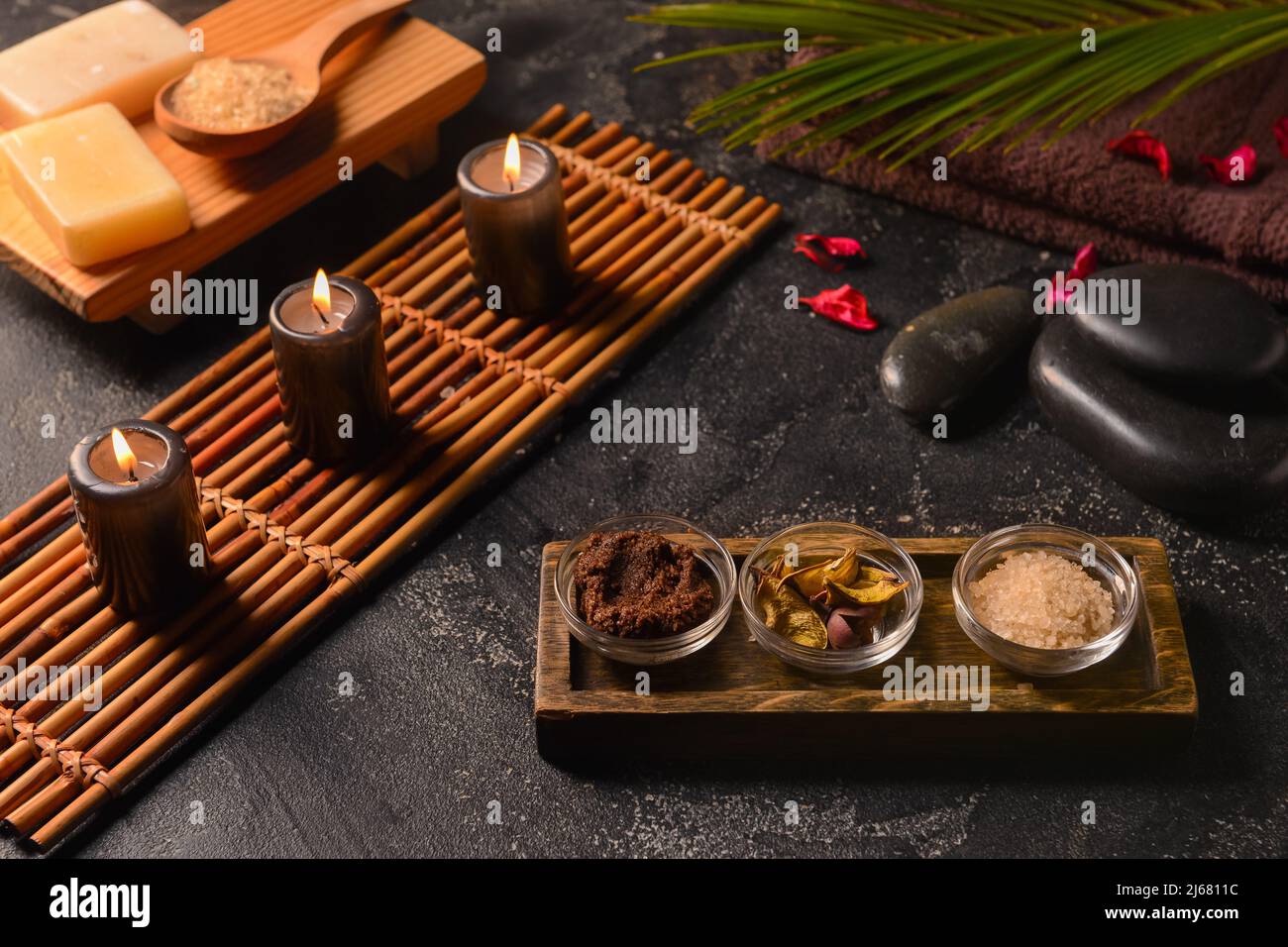 Spa composition with burning candles on dark background Stock Photo - Alamy