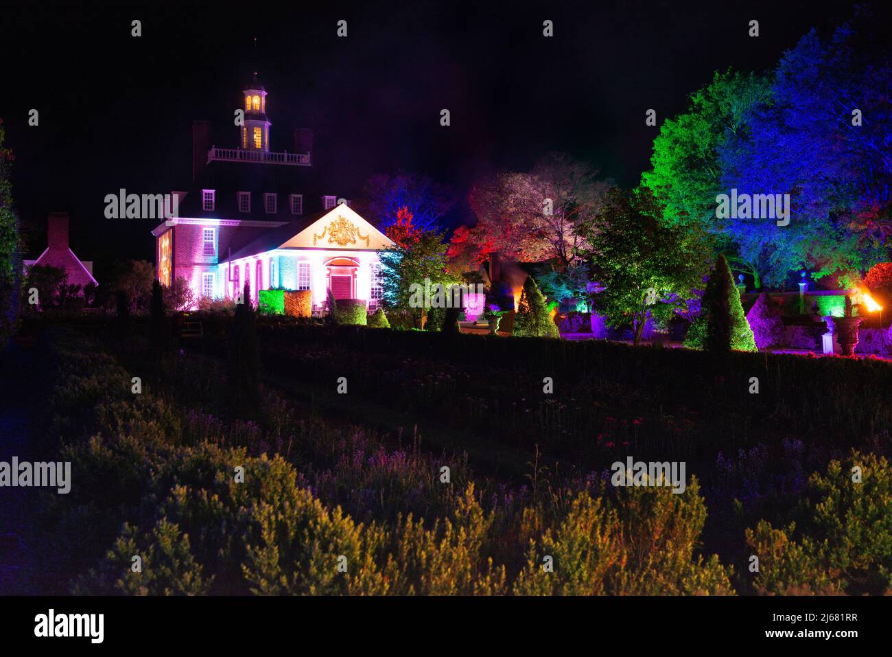 Governors Palace, Garden View atnight, Colorful CW Light show. Colonial Williamsburg. Colorful and dramatic spotlights.Copy space. Landscape view. Stock Photo