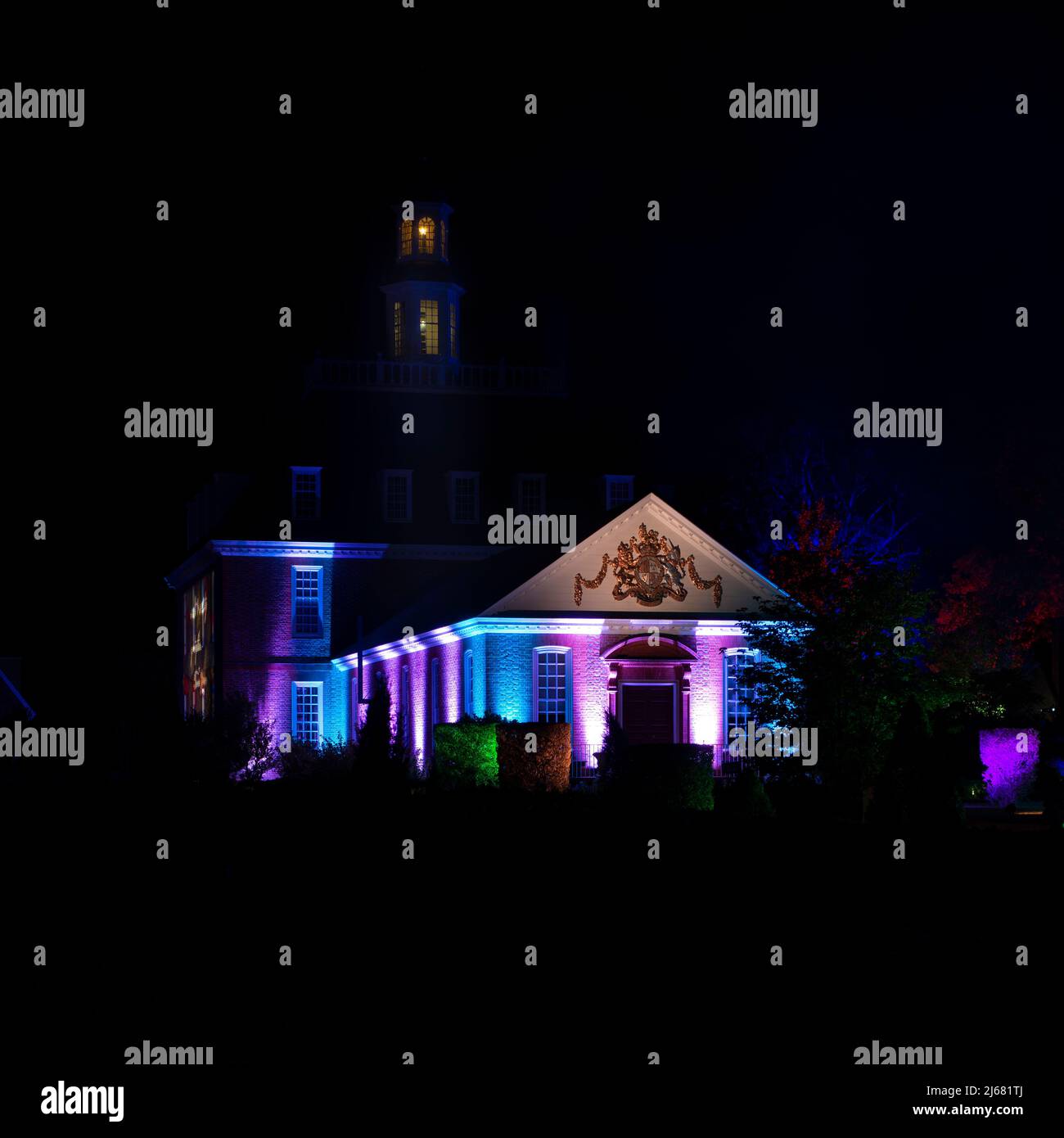 Governors Palace, Garden View in the black of night, Colorful CW Light show. Colonial Williamsburg. Colorful and dramatic spotlights.Copy space. Stock Photo