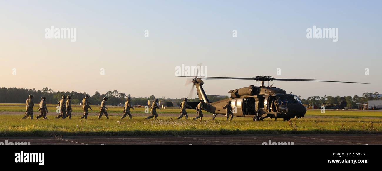U.S. special operations service members load a UH-60 Black Hawk ...