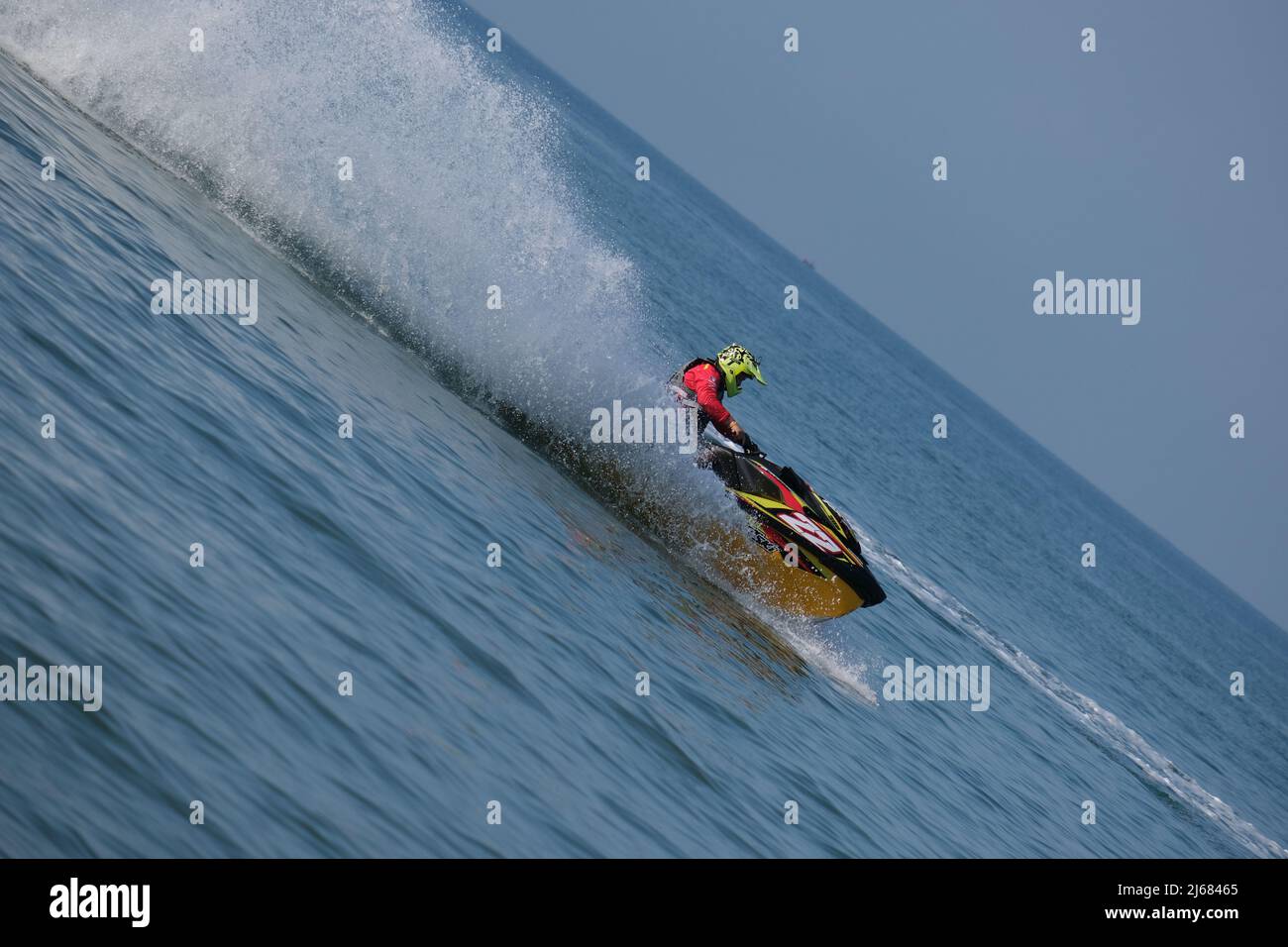 Jet ski is flying fast, making a wall of splashes Stock Photo
