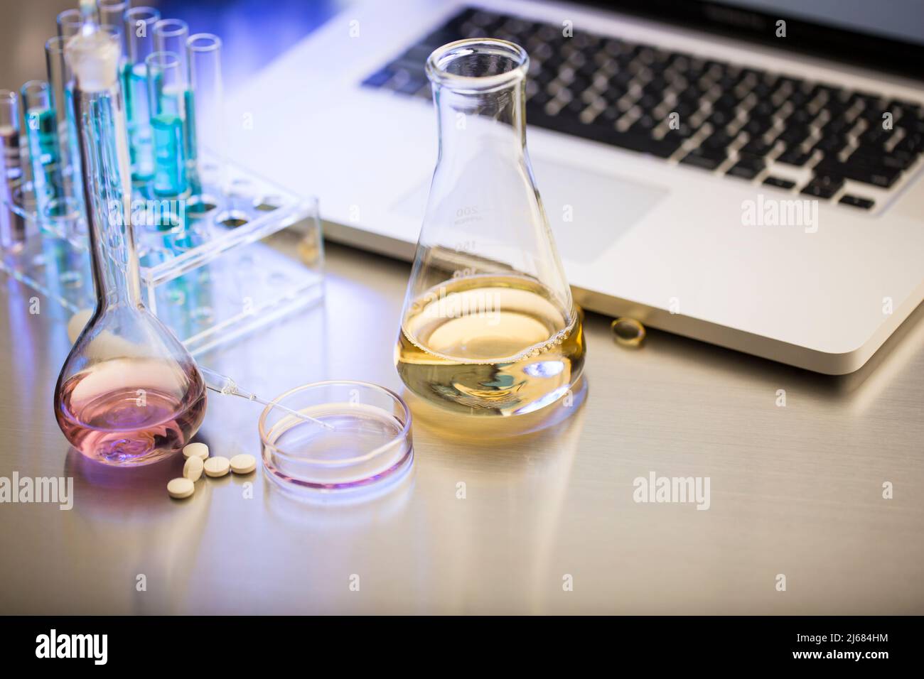 Pills and chemical equipment On the operating table of the drug testing lab - stock photo Stock Photo