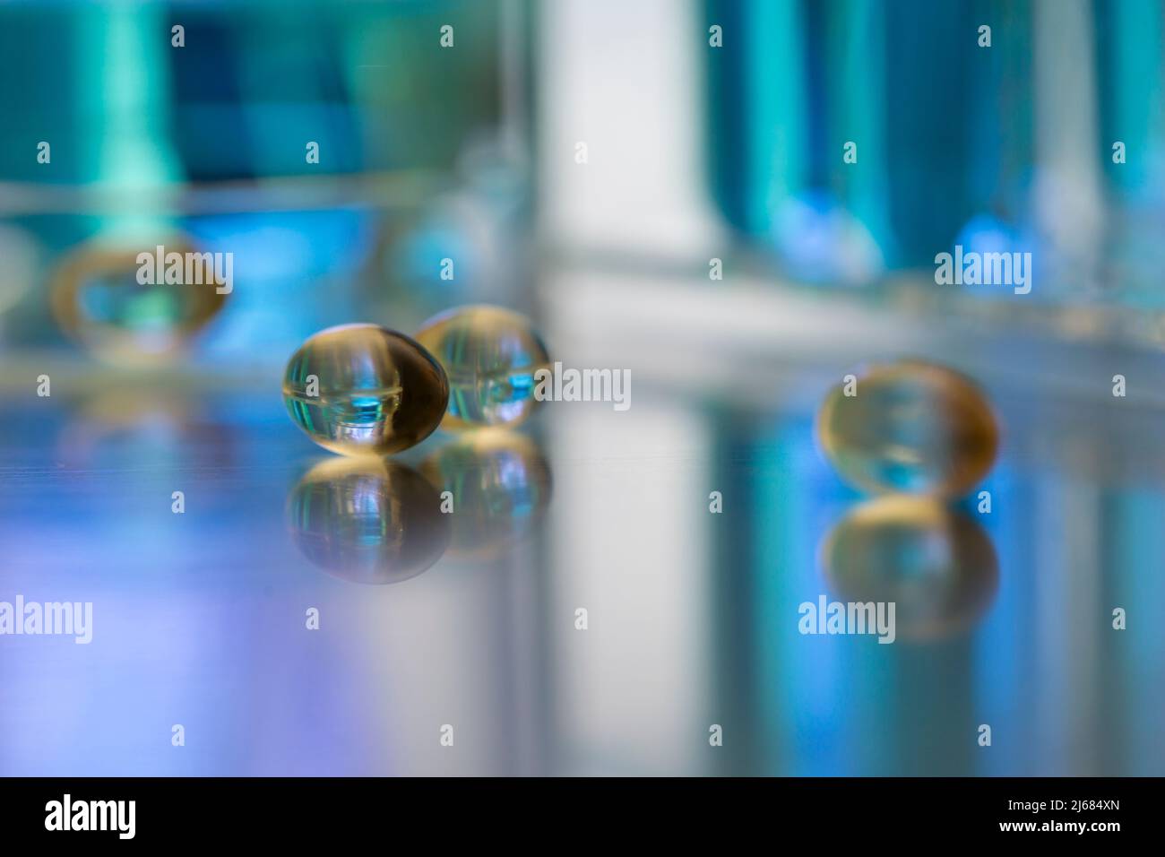 Soft capsules scattered on a medical research bench - stock photo Stock Photo
