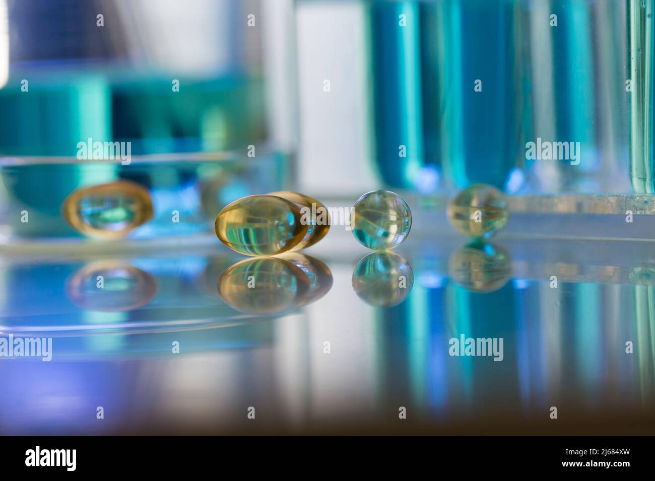 Soft capsules are scattered on the drug ingredient testing bench - stock photo Stock Photo